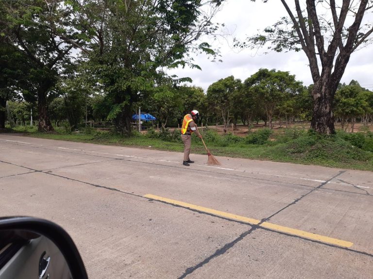 ร.ต.ต.มงคล ปัจฉิมบุตร กวาดเศษดินออกจากผิวทางจราจร